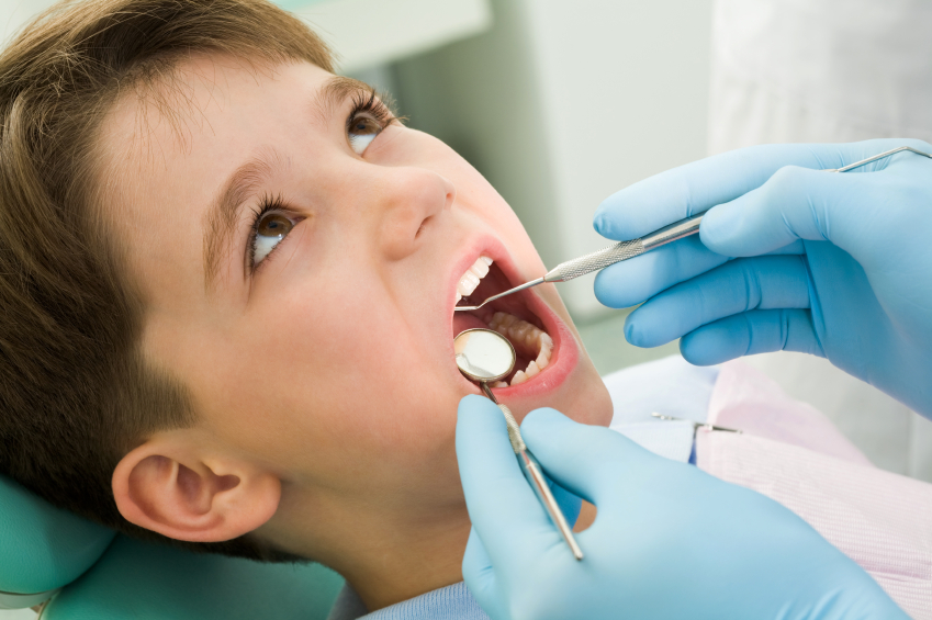 Close-up of little boy opening his mouth during dental checkup